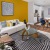 Yellow accent wall in apartment living room