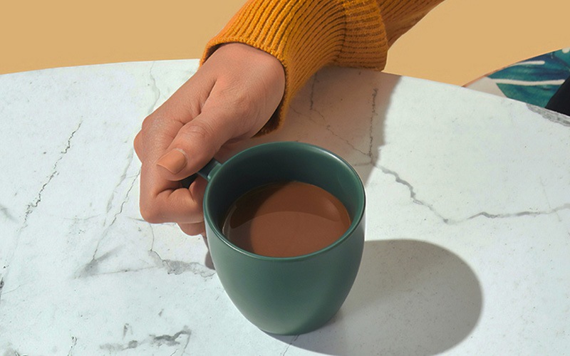 lifestyle of a hand holding a mug